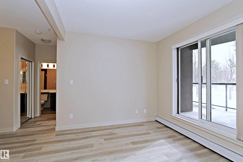 Light wood-finish flooring extending throughout the space - 140 308 Ambleside Link Link, Edmonton, AB 