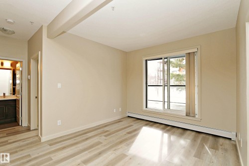 Neutral-toned walls complement the light wood-finish flooring - 140 308 Ambleside Link Link, Edmonton, AB 