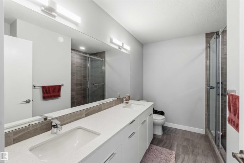Full-width vanity with dual integrated sinks, white cabinetry, and polished chrome hardware - 33 1729 Keene Crescent, Edmonton, AB 