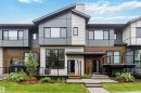 Modern townhome exterior featuring multi-textured facade with wood-look siding and horizontal panels - 33 1729 Keene Crescent, Edmonton, AB 