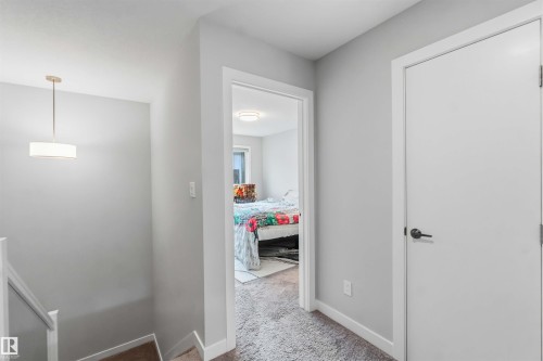 Hallway with light gray walls and white trim - 33 1729 Keene Crescent, Edmonton, AB 