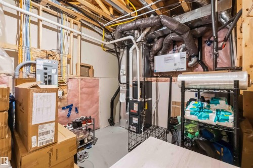 Utility space featuring exposed ceiling joists, electrical panel, HVAC system, and insulated walls - 33 1729 Keene Crescent, Edmonton, AB 