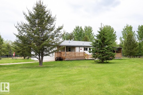 Expansive green lawn with mature trees - 209 5128 Highway 18, Rural Barrhead County, AB 