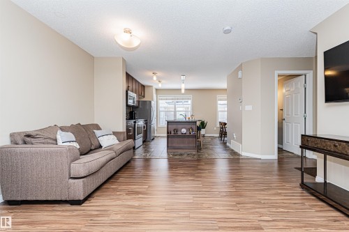Expansive living area featuring wide plank wood-finish flooring - 31 4029 Orchards Drive, Edmonton, AB 