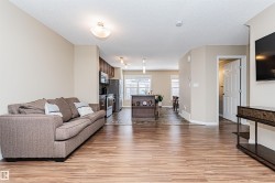 Expansive living area featuring wide plank wood-finish flooring - 