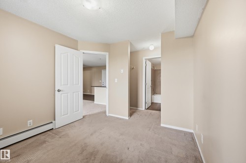Neutral-toned carpeting throughout - 304 11804 22 Avenue, Edmonton, AB 