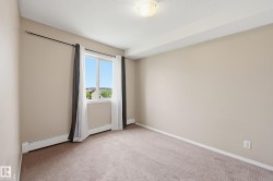 Neutral toned walls with a window featuring white trim and a subtle landscape - 