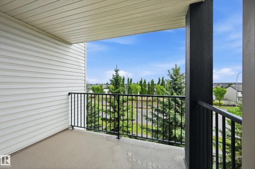 Exterior balcony featuring a concrete surface and black metal railings - 304 11804 22 Avenue, Edmonton, AB 