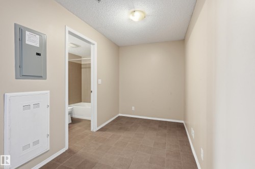Room featuring neutral wall tones and tile flooring - 304 11804 22 Avenue, Edmonton, AB 