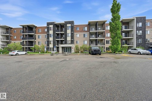 Multi-story building featuring a brick and stone facade with multiple balconies - 304 11804 22 Avenue, Edmonton, AB 