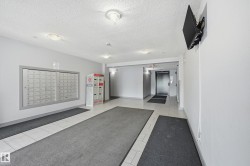 Lobby area featuring built-in mailboxes, secure package lockers, and tile flooring - 