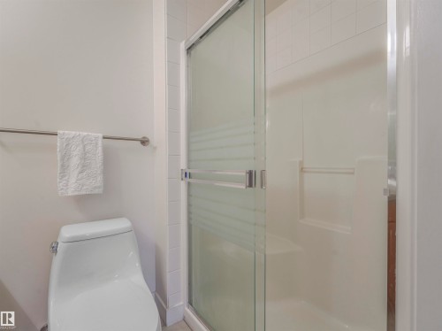 Shower stall with a sliding glass door and integrated shelving - 409 10333 112 Street, Edmonton, AB 