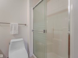 Shower stall with a sliding glass door and integrated shelving - 