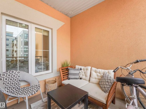 Private balcony featuring a window with white trim, textured peach-toned walls, and a white paneled ceiling - 409 10333 112 Street, Edmonton, AB 