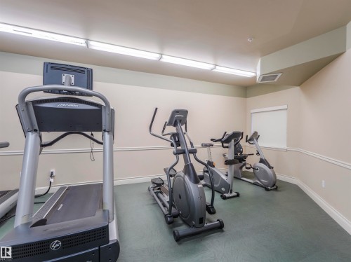 Dedicated fitness space featuring a treadmill, elliptical, and stationary bikes - 409 10333 112 Street, Edmonton, AB 