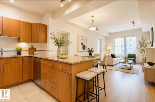 Open-concept living area featuring a kitchen with wood cabinetry, light-toned countertops, and a full tile backsplash - 409 10333 112 Street, Edmonton, AB 