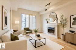 Living area featuring light wood-finish flooring and a tiled fireplace with a stainless steel insert - 