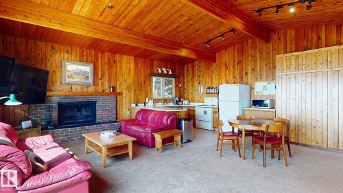 98 Argentia Beach, Rural Wetaskiwin County, AB - Indoor Photo Showing Living Room With Fireplace