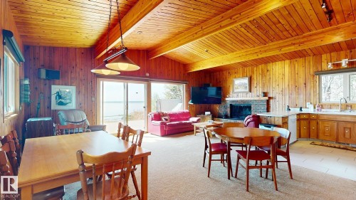 98 Argentia Beach, Rural Wetaskiwin County, AB - Indoor Photo Showing Dining Room With Fireplace