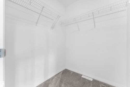Interior closet featuring white walls, wire shelving, and gray carpet flooring - 1534 157 Street, Edmonton, AB 