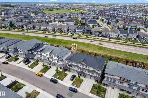 Aerial overview of a residential area featuring multiple townhome units with attached garages - 1534 157 Street, Edmonton, AB 