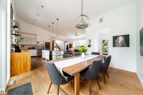 Open-concept living space featuring wood-finish flooring and a vaulted ceiling - 14508 78 Avenue, Edmonton, AB 