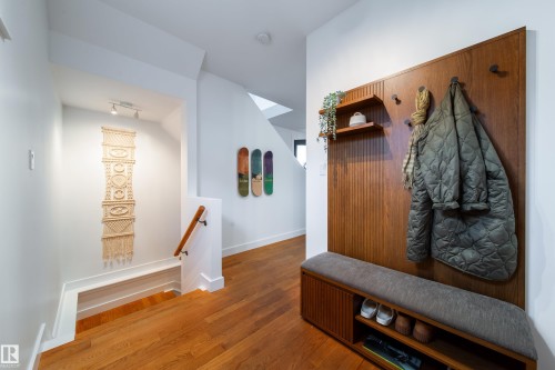 Rich wood-finish flooring complements white walls in this entry area - 14508 78 Avenue, Edmonton, AB 