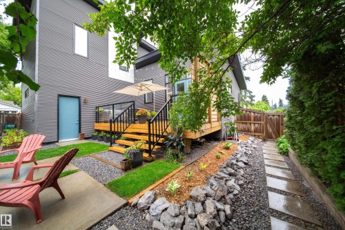 Contemporary multi-level exterior featuring corrugated metal siding and a light blue entry door - 14508 78 Avenue, Edmonton, AB 