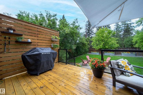 Expansive wood deck with horizontal slat privacy wall and black metal railing - 14508 78 Avenue, Edmonton, AB 