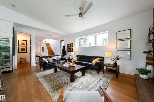 Open-concept living area featuring wood-finish flooring, a contemporary ceiling fan, and recessed lighting - 14508 78 Avenue, Edmonton, AB 