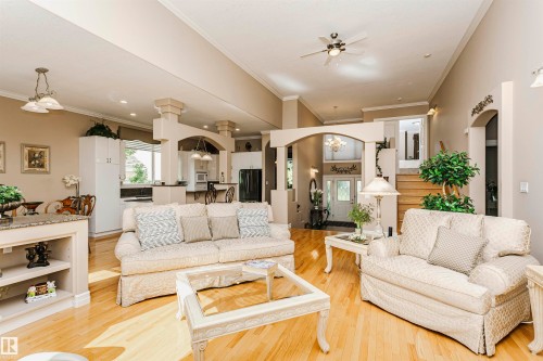 Spacious living area featuring high ceilings, wood-finish flooring, and multiple arched doorways - 116 Darlington Crescent, Edmonton, AB 