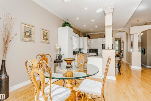 Open-concept main living area with wood-finish flooring, crown molding, and recessed lighting - 116 Darlington Crescent, Edmonton, AB 