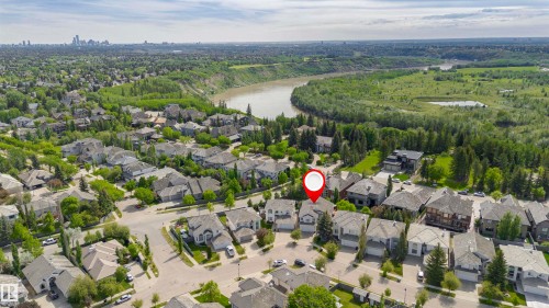 Aerial perspective showcasing the residential neighborhood with a river and natural landscape - 116 Darlington Crescent, Edmonton, AB 