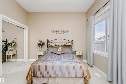 Room featuring neutral-toned walls, white baseboards, and light-colored carpeting - 116 Darlington Crescent, Edmonton, AB 