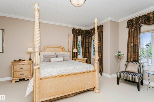 Spacious bedroom with neutral wall tones and crown molding - 116 Darlington Crescent, Edmonton, AB 