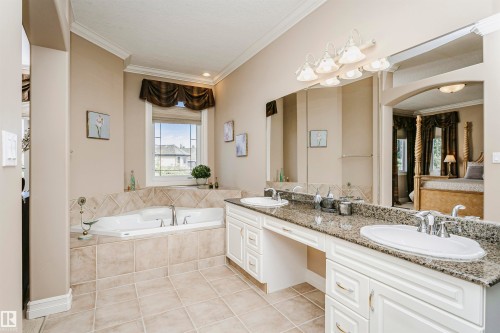 Spacious bathroom featuring a built-in soaking tub, dual vanity with undermount sinks, and granite countertops - 116 Darlington Crescent, Edmonton, AB 