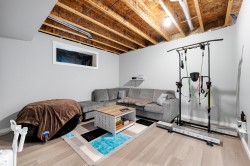 Recessed window opening, light gray wall paint, and exposed ceiling joists - 