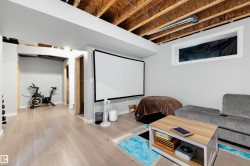 Spacious lower level featuring wood-finish flooring, recessed lighting, and a window for natural light - 