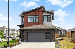 Modern architectural design featuring a multi-tone exterior with dark red and grey siding - 