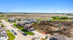 Aerial depiction of a developing neighborhood with established homes and active construction - 