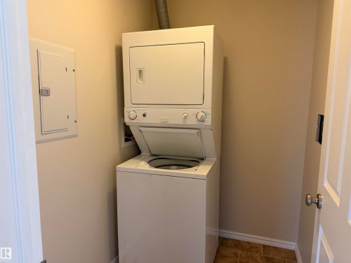 Dedicated laundry area featuring a stackable washer and dryer unit - 118 7801 Golf Course Road, Stony Plain, AB 