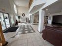 Spacious entryway featuring a decorative tile floor pattern - 118 7801 Golf Course Road, Stony Plain, AB 