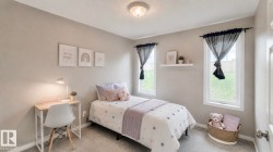 Carpeted room featuring two single-pane windows, a ceiling-mounted light fixture, light gray walls, and white baseboards - 