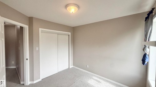 Neutral-toned walls complement plush carpet flooring - 9 225 Blackburn Drive E, Edmonton, AB 