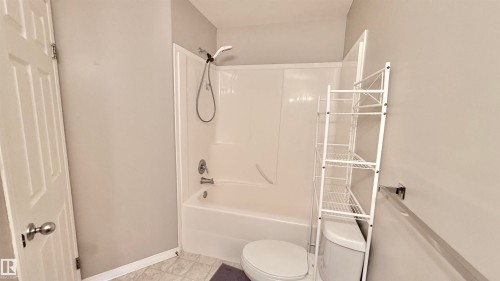 Full white bathtub and shower combination unit - 9 225 Blackburn Drive E, Edmonton, AB 