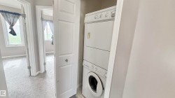 Dedicated laundry closet featuring a stacked washer and dryer - 
