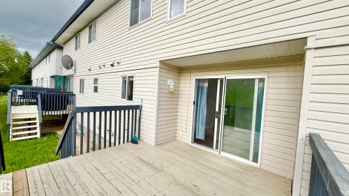 Deck with horizontal wood planks and black painted railing - 9 225 Blackburn Drive E, Edmonton, AB 
