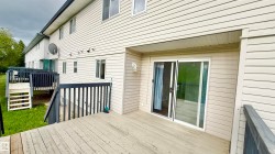 Deck with horizontal wood planks and black painted railing - 