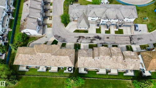 Aerial perspective showcasing a residential development with multiple townhome-style units - 9 225 Blackburn Drive E, Edmonton, AB 
