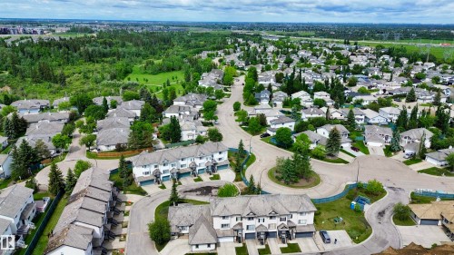 Aerial perspective showcasing a residential community with varied housing styles - 9 225 Blackburn Drive E, Edmonton, AB 